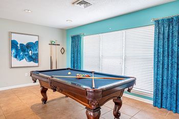 Community room with big screen television and pool table